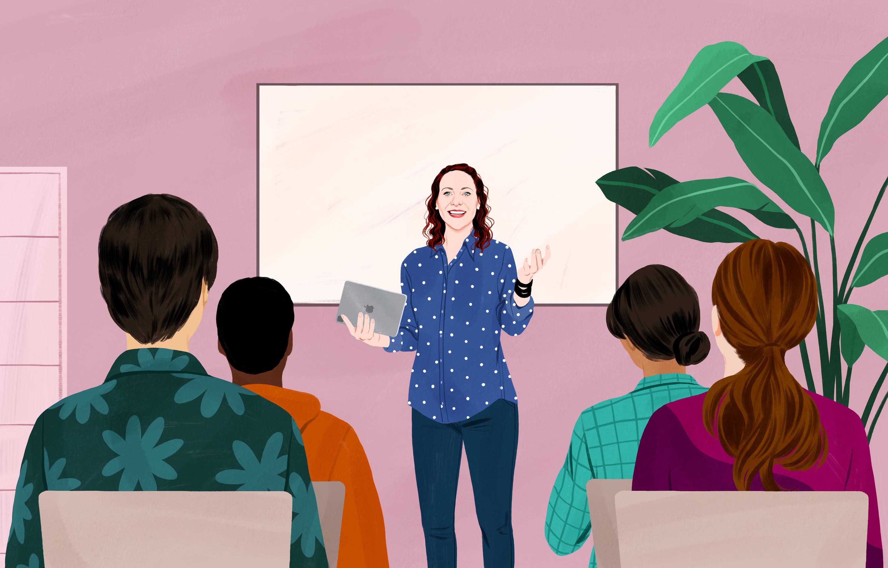 جيسيكا تبتسم حاملة جهاز iPad، وتقف أمام مجموعة من البالغين، وتشير بيدها وكأنها تشرح موضوعاً ما. 