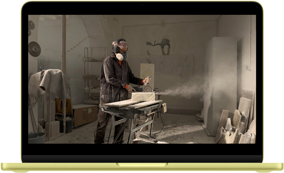 MacBook Neo, citrus color, QuickTime video onscreen