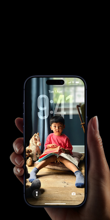 Hand holding iPhone 17 Pro, Messages pop-up on personalised Lock Screen